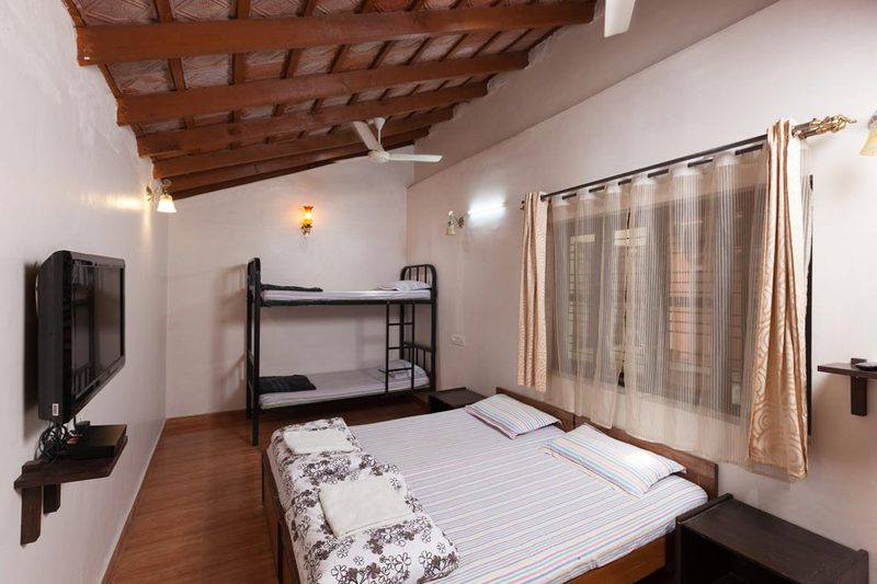 Cottage bedroom with king bed and bunk bed