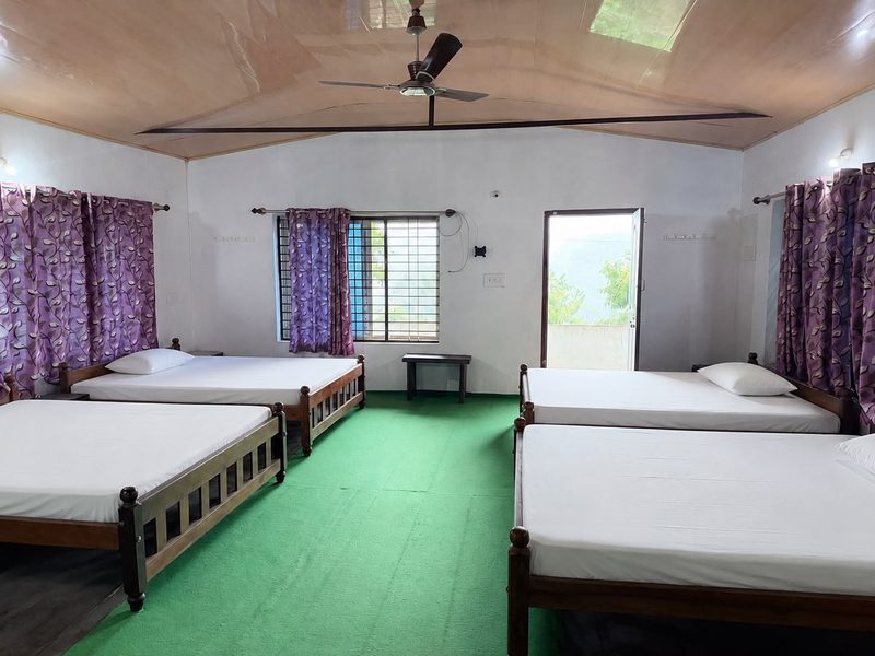Large five-bed room with high ceiling and doors opening to valley views