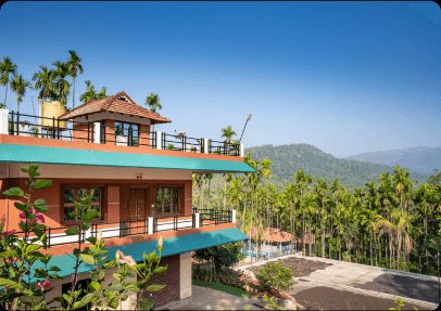 Official gallery image of a resort room with a balcony overlooking a lush green valley.