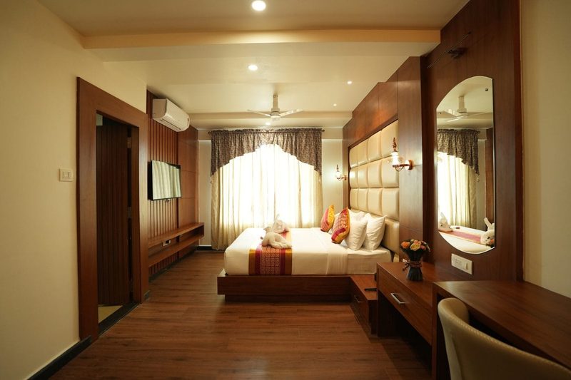 Presidential Suite with a king-size bed, dressing table and wood-panelled television wall