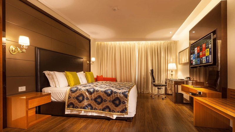 Suite room with a king bed and separate living area.