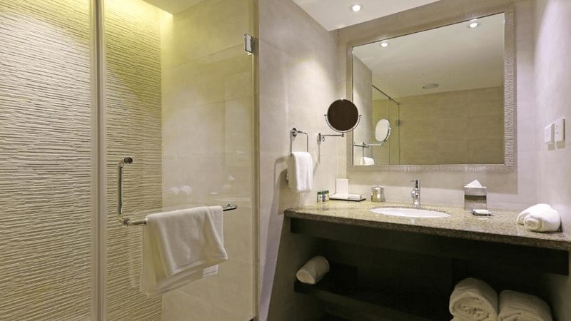 Deluxe Room with a king bed, seating area and work desk.