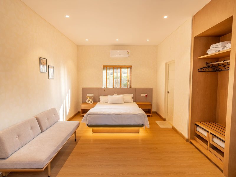 Bedroom with a king bed, daybed and built-in wardrobe.
