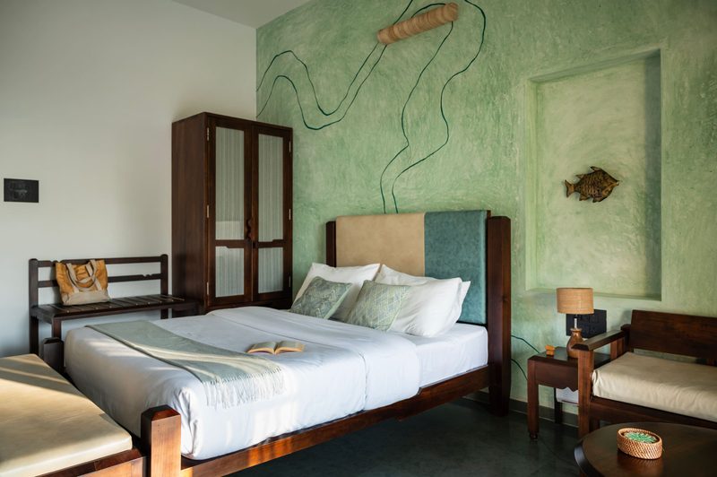 Kedaka, in its soft green palette, with river-line artwork on the wall