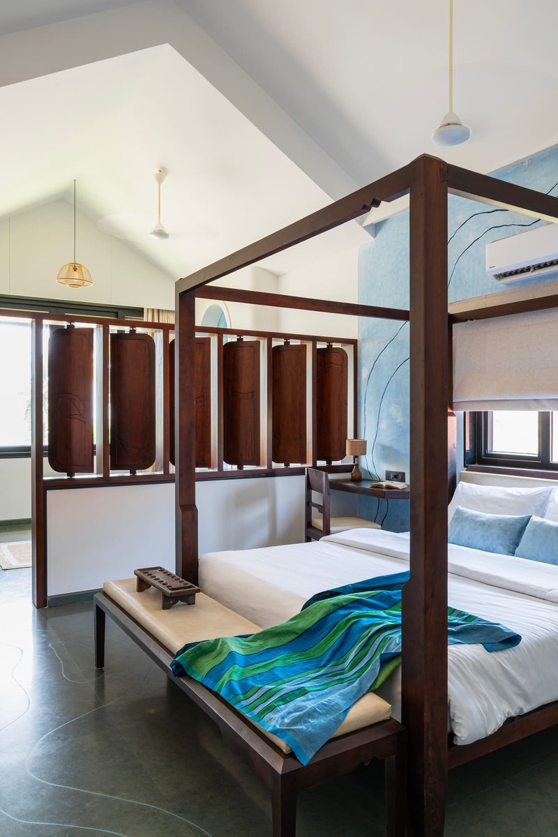 The Varahi master suite with its four-poster bed, vaulted ceiling and carved wooden divider