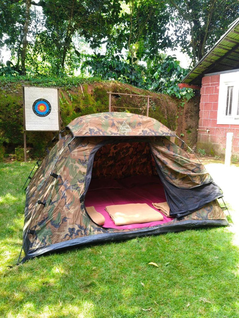Tent stay interior with mattress and blankets ready for guests