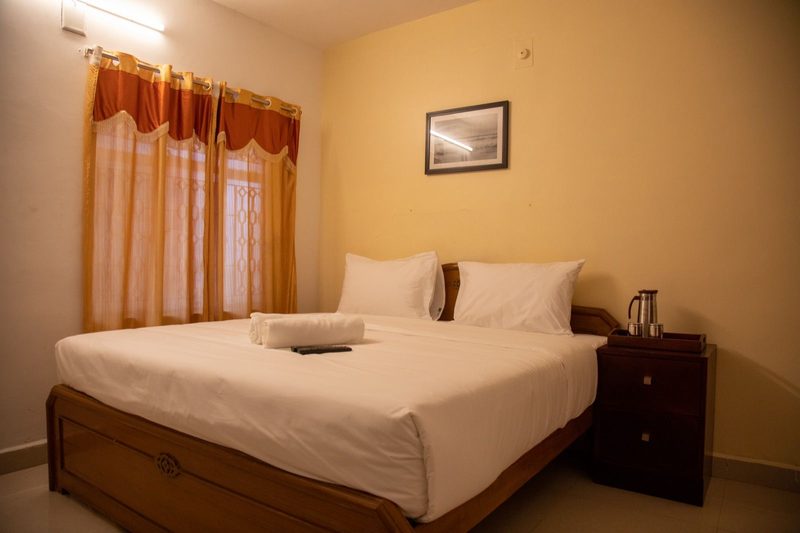 Standard room with a made-up double bed