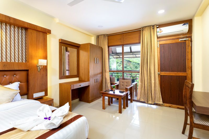 Premium Valley View Room seen wide, with dressing table, wardrobe and balcony seating