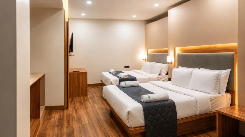 The Family Suite at The Lovedale — two double beds in one large room, warm wood and soft lighting